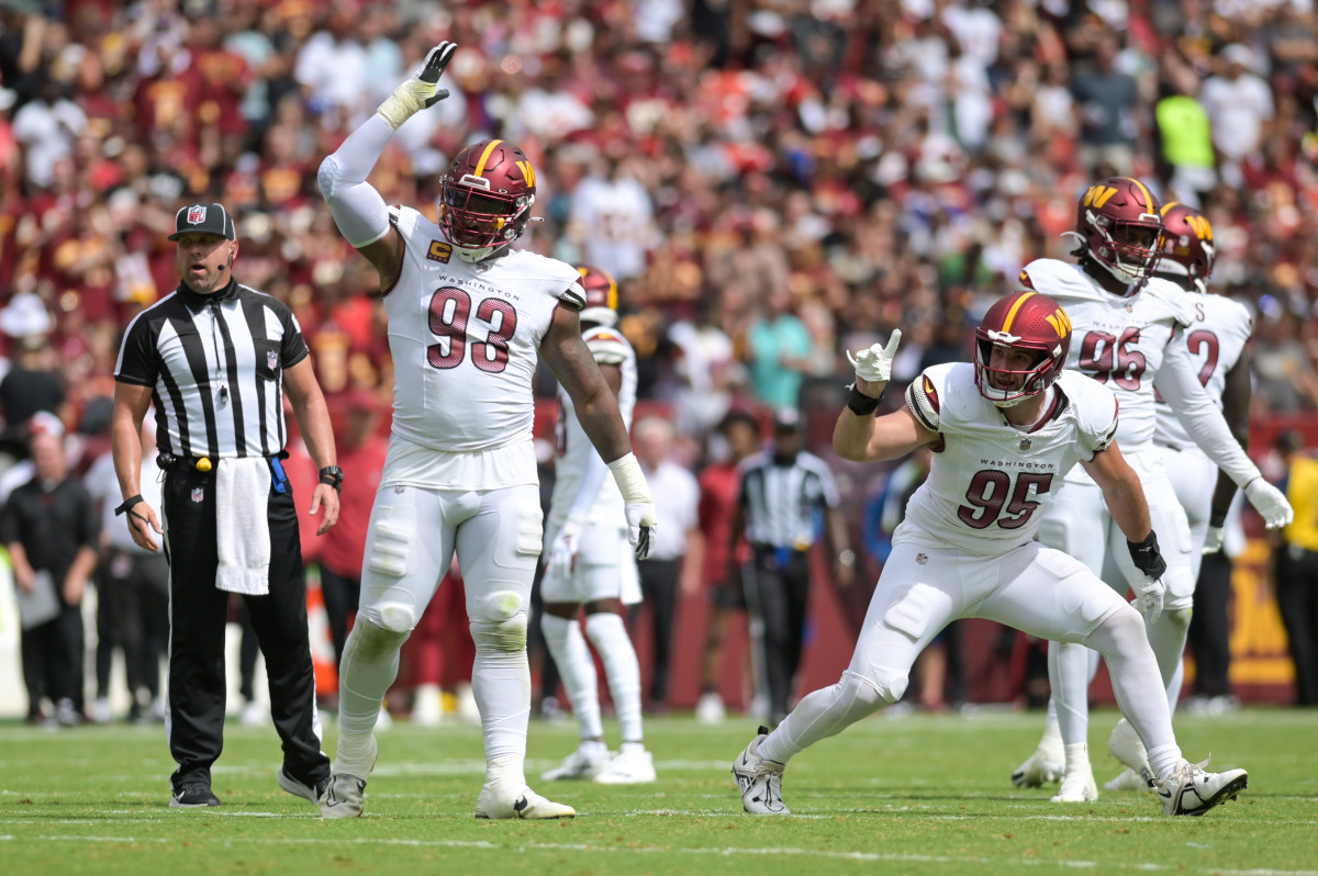 Sep 10, 2023; Landover, Maryland, USA; Washington Commanders defensive tackle Jonathan Allen (93) and defensive end Casey Toohill (95) celebrate after tackling Arizona Cardinals running back Keaontay Ingram (not pictured) behind the line of scrimmage during the first half at FedExField. Mandatory Credit: Tommy Gilligan-USA TODAY Sports